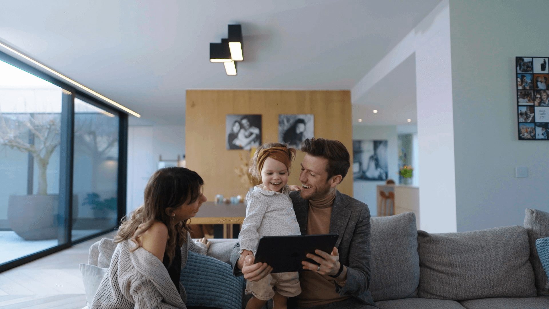 Johan Krijgsman, CEO van ERA, en zijn vrouw en kind kijken naar een tablet.