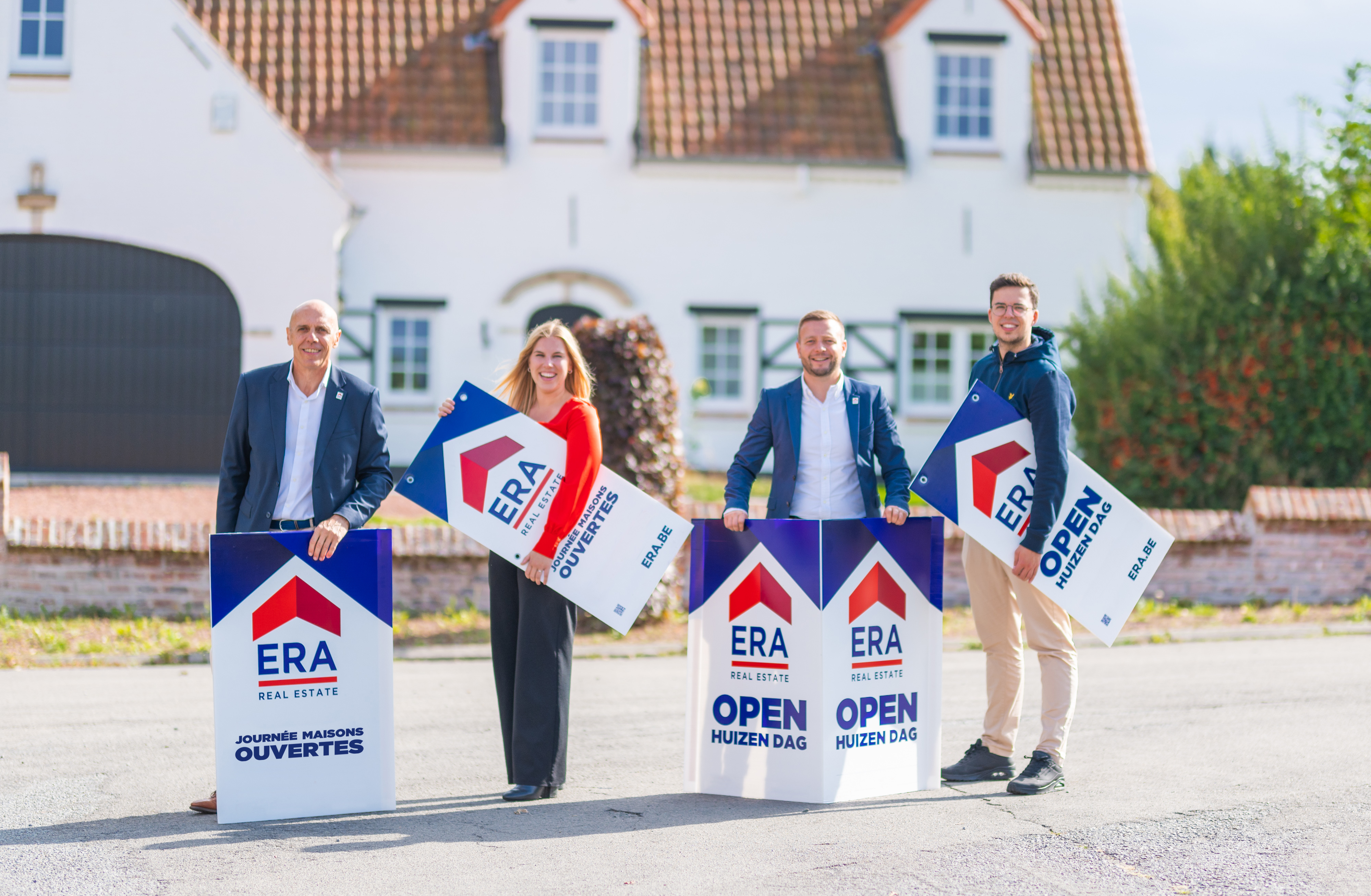 Real estate agents with signs for ERA Open Houses Day.