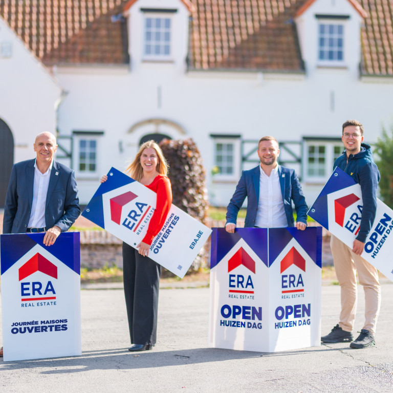 Real estate agents with signs for ERA Open Houses Day.