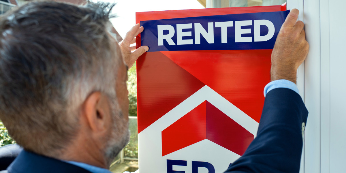 The real estate agent puts rented on the sign